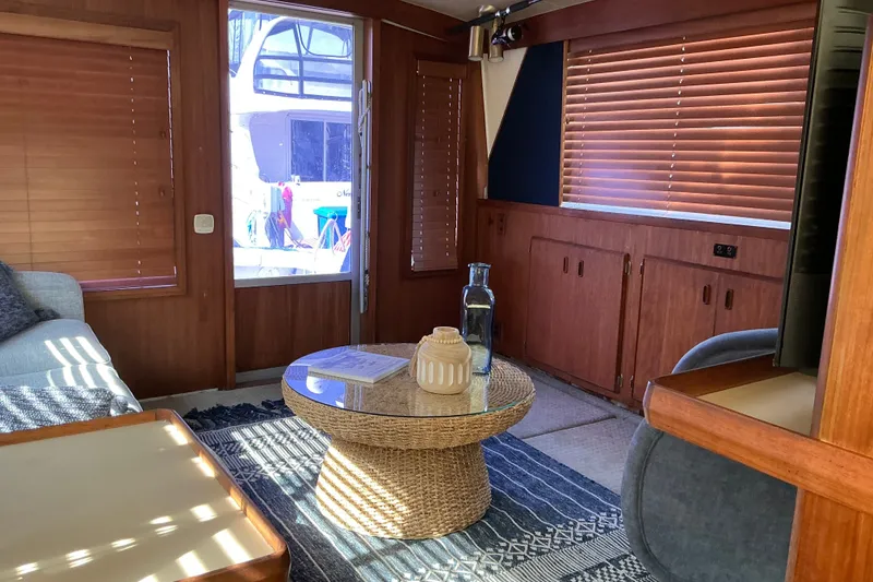Slide: The Image of Interior of a 1985 Bertram 42 Convertible yacht with wooden blinds and cozy seating. - 9