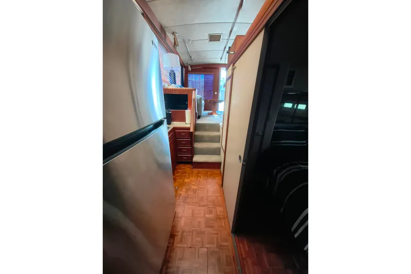 Slide: The Image of Interior view of 1985 Bertram 42 Convertible yacht with wood flooring and modern amenities. - 19