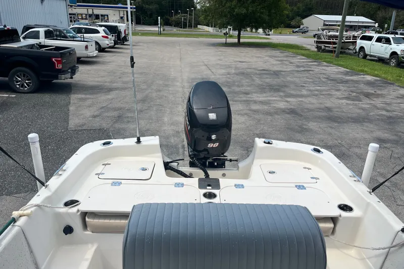 Slide: The Image of 2013 Carolina Skiff 178 DLV boat with Suzuki 90 engine in parking lot. - 16