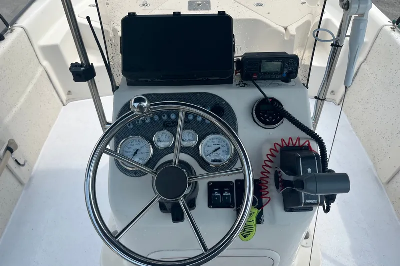 Slide: The Image of 2013 Carolina Skiff 178 DLV boat console with steering wheel and navigation instruments. - 15