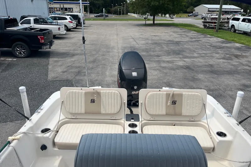 Slide: The Image of 2013 Carolina Skiff 178 DLV boat with Suzuki 90 engine in parking lot. - 17