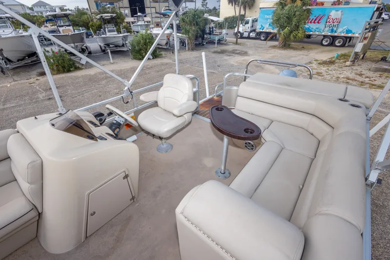 Slide: The Image of 2016 South Bay 5220CR pontoon boat interior with beige seating and control console. - 22