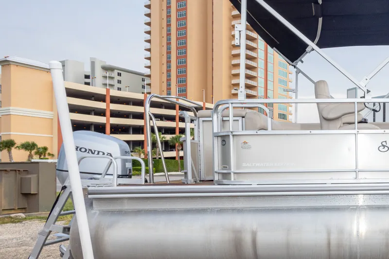 Slide: The Image of 2016 South Bay 5220CR pontoon boat with Honda engine, docked near tall buildings. - 9
