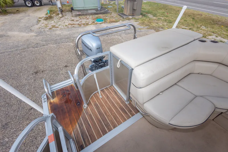 Slide: The Image of 2016 South Bay 5220CR pontoon boat with Honda 90 engine, featuring spacious seating and wooden deck. - 18