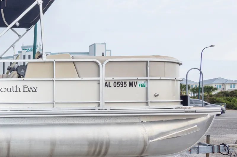 Slide: The Image of 2016 South Bay 5220CR pontoon boat on trailer, side view with registration details. - 10