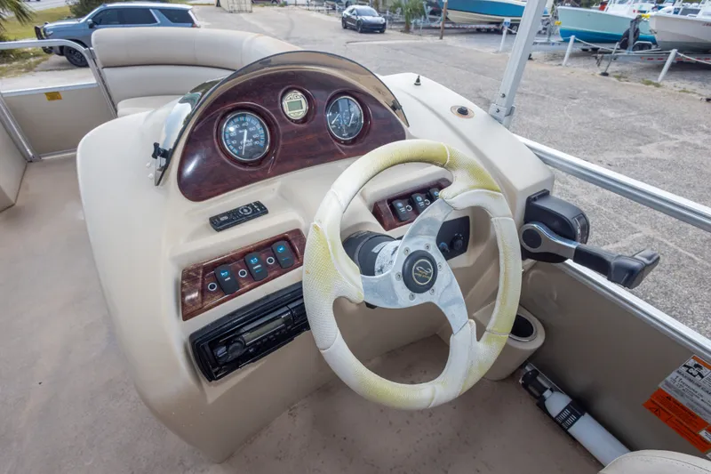 Slide: The Image of Steering console of a 2016 South Bay 5220CR pontoon boat with gauges and controls. - 29