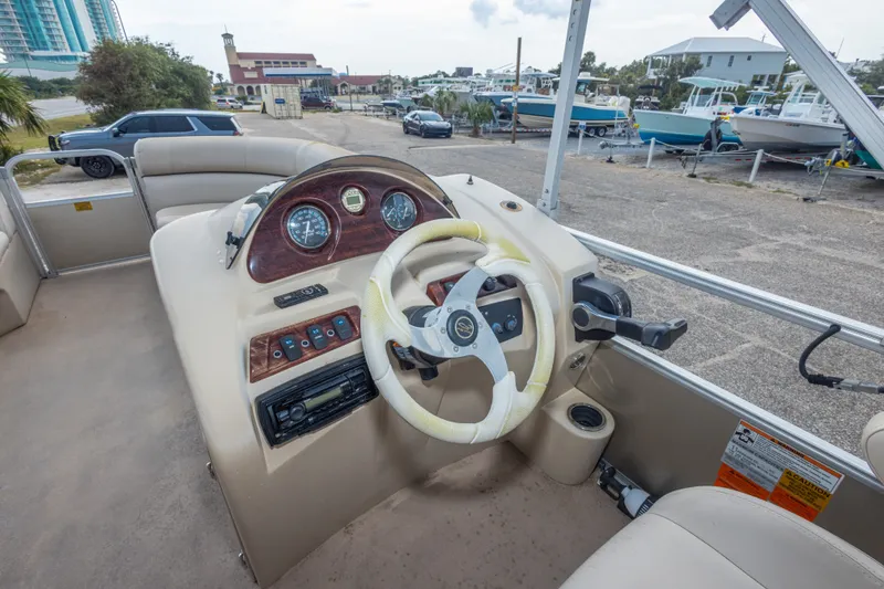 Slide: The Image of 2016 South Bay 5220CR boat dashboard with steering wheel and control panel. - 28