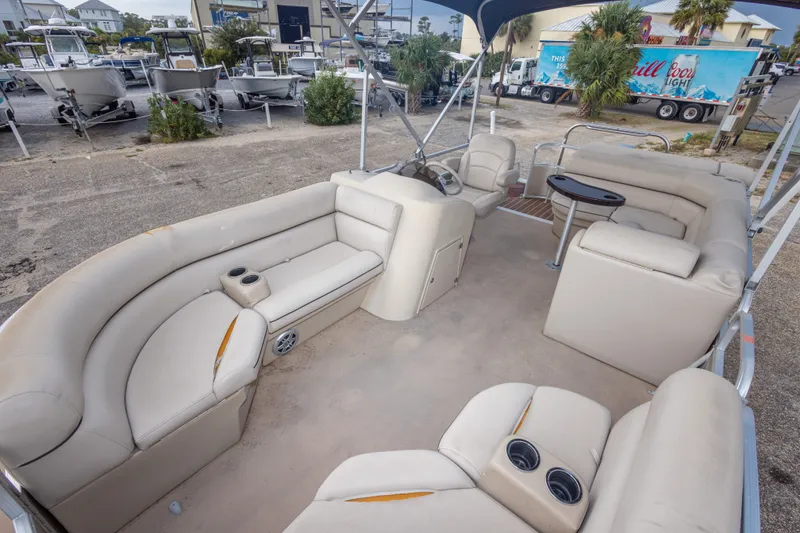 Slide: The Image of 2016 South Bay 5220CR pontoon boat with spacious seating and canopy in a marina setting. - 25