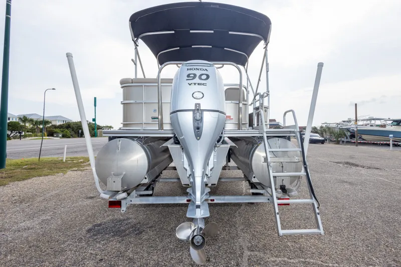 Slide: The Image of 2016 South Bay 5220CR pontoon boat with Honda 90 VTEC engine, parked on trailer. - 38