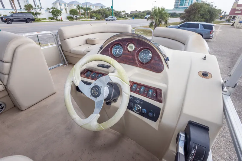 Slide: The Image of 2016 South Bay 5220CR boat interior with steering wheel and dashboard controls. - 17