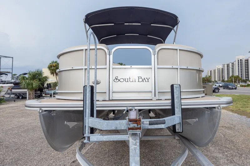 Slide: The Image of 2016 South Bay 5220CR pontoon boat on trailer, parked outdoors. - 11