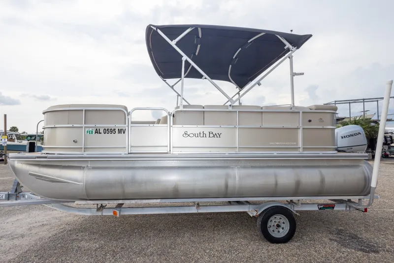 Slide: The Image of 2016 South Bay 5220CR pontoon boat with Honda motor on trailer. - 13