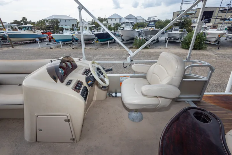 Slide: The Image of 2016 South Bay 5220CR boat interior with steering console and captain's chair. - 31