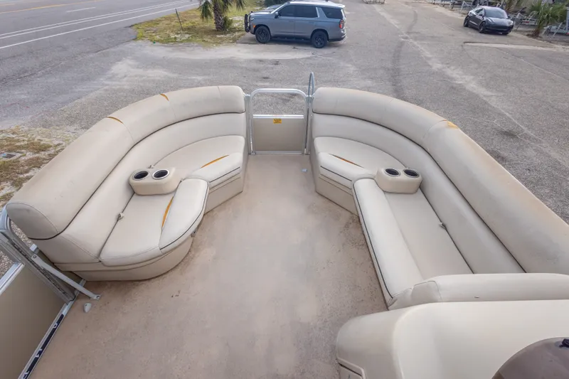 Slide: The Image of 2016 South Bay 5220CR pontoon boat interior with beige seating and cup holders. - 26