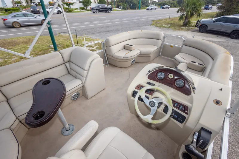Slide: The Image of 2016 South Bay 5220CR pontoon boat interior with beige seating and steering console. - 32