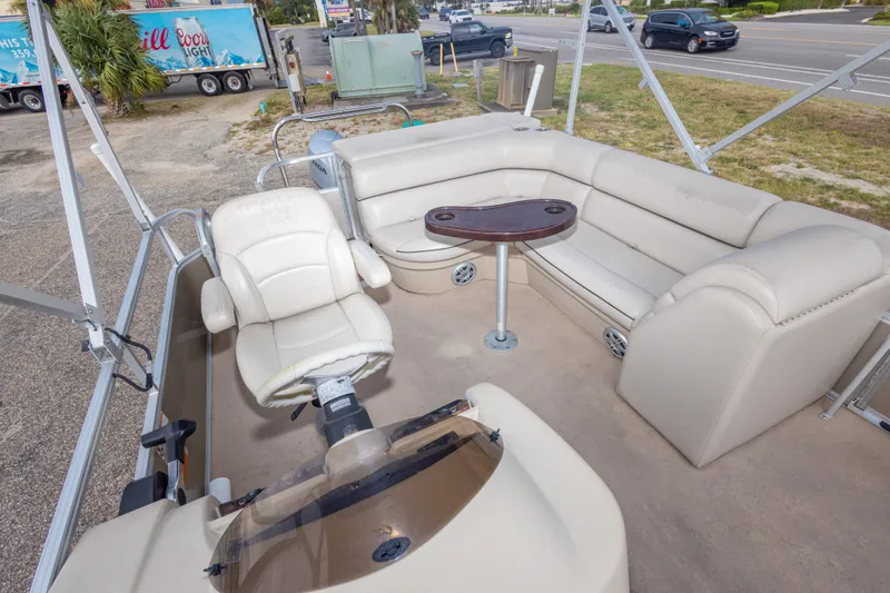 Slide: The Image of 2016 South Bay 5220CR pontoon boat interior with beige seating and steering console. - 21
