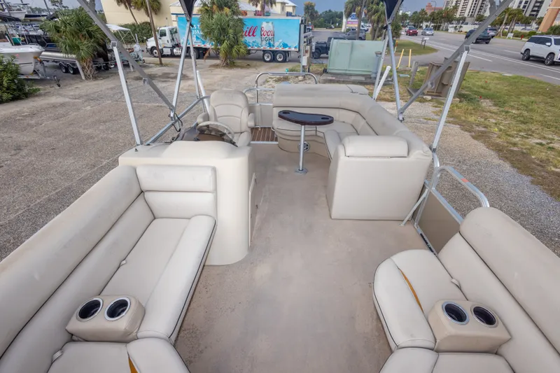 Slide: The Image of 2016 South Bay 5220CR pontoon boat interior with beige seating and cup holders. - 23