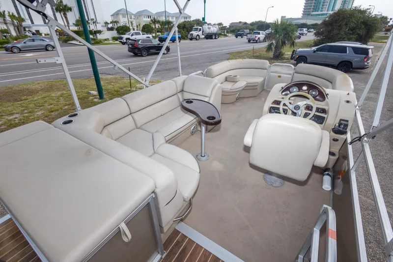 Slide: The Image of 2016 South Bay 5220CR pontoon boat interior with beige seating and steering console. - 34