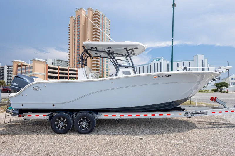 Slide: The Image of 2016 Sea Fox 288 Commander boat on trailer, urban backdrop. - 12