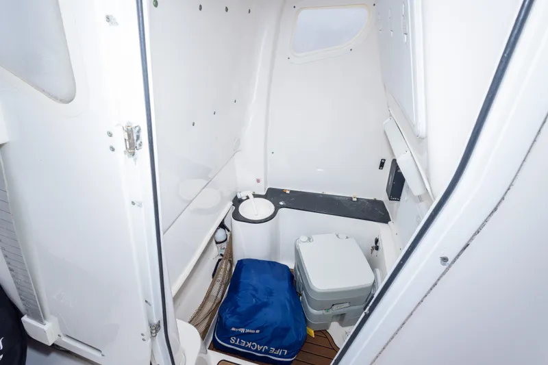Slide: The Image of Interior of 2016 Sea Fox 288 Commander boat with portable toilet and storage. - 31