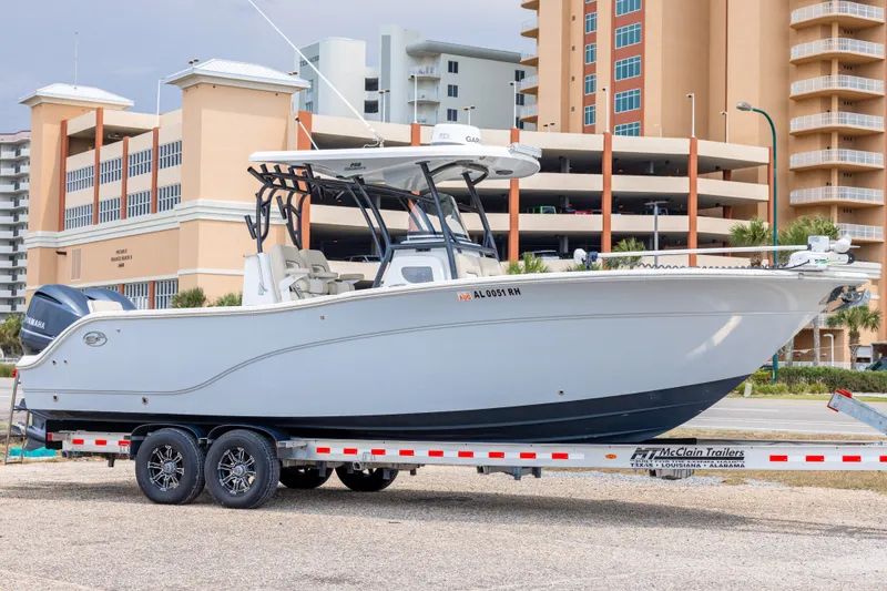 The Image of 2016 Sea Fox 288 Commander boat on trailer, parked near modern buildings. - 0