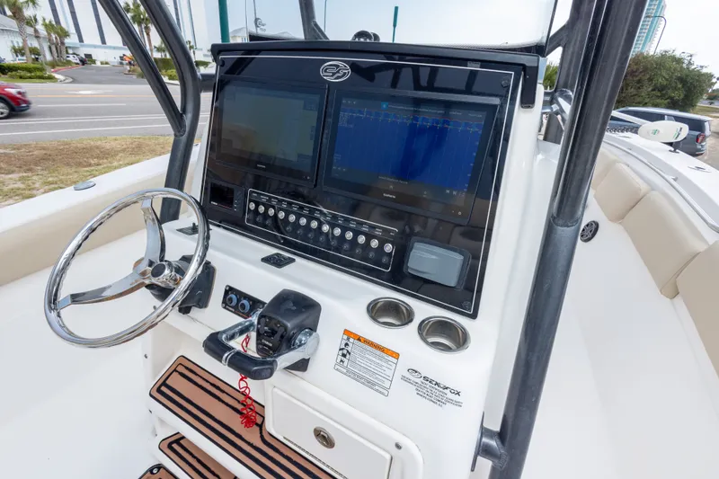 Slide: The Image of 2016 Sea Fox 288 Commander boat dashboard with steering wheel and navigation screens. - 26
