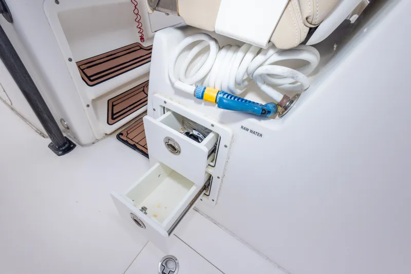 Slide: The Image of 2016 Sea Fox 288 Commander boat interior with storage drawers and coiled hose. - 56