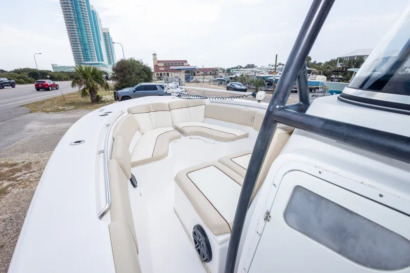 Slide: The Image of 2016 Sea Fox 288 Commander boat with spacious seating, docked near a coastal road. - 30