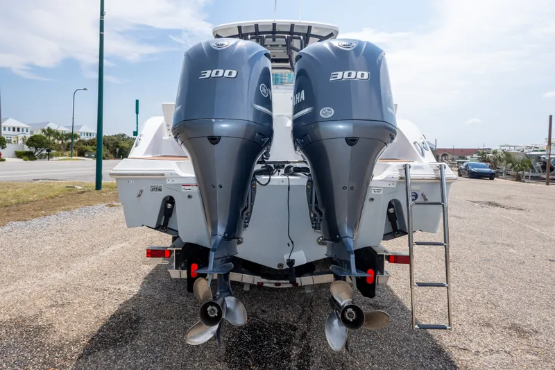 Slide: The Image of 2016 Sea Fox 288 Commander with twin Yamaha 300 engines, parked on a gravel lot. - 14