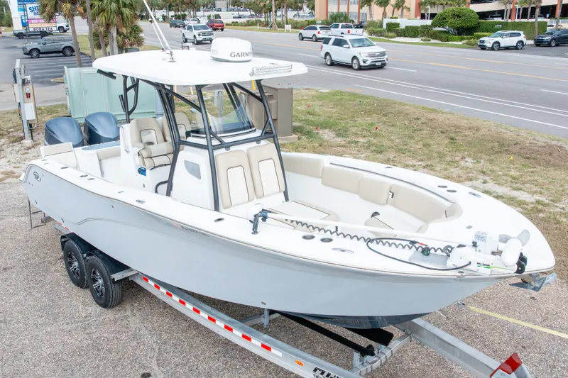 Slide: The Image of 2016 Sea Fox 288 Commander boat on trailer, parked near a road. - 1