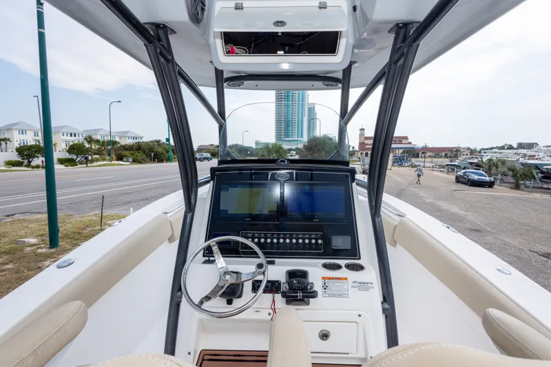 Slide: The Image of 2016 Sea Fox 288 Commander boat dashboard with steering wheel and navigation controls. - 23