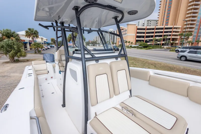 Slide: The Image of 2016 Sea Fox 288 Commander boat interior with seating, parked near a coastal road. - 44