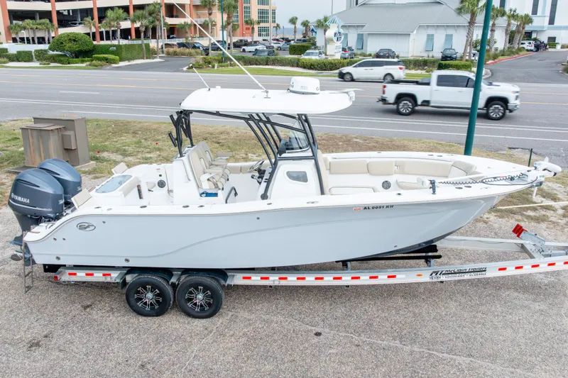 Slide: The Image of 2016 Sea Fox 288 Commander boat on trailer, parked near a road. - 2