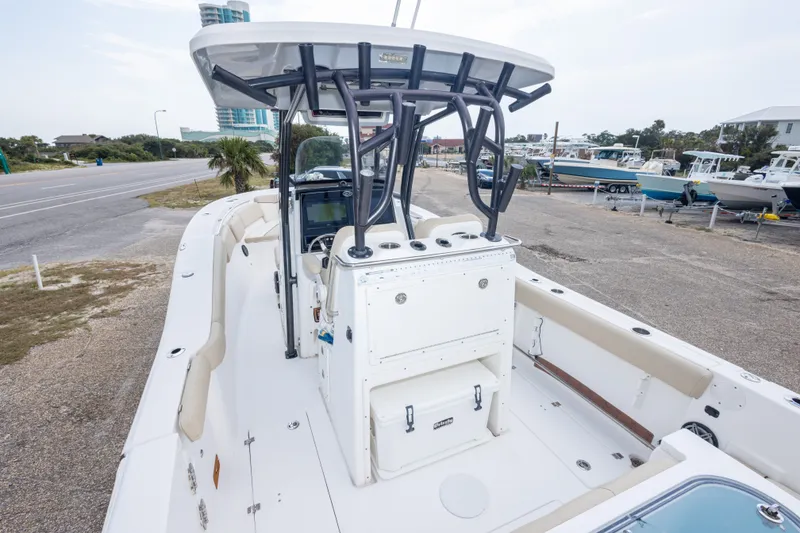 Slide: The Image of 2016 Sea Fox 288 Commander boat with center console and T-top, parked near a road. - 22