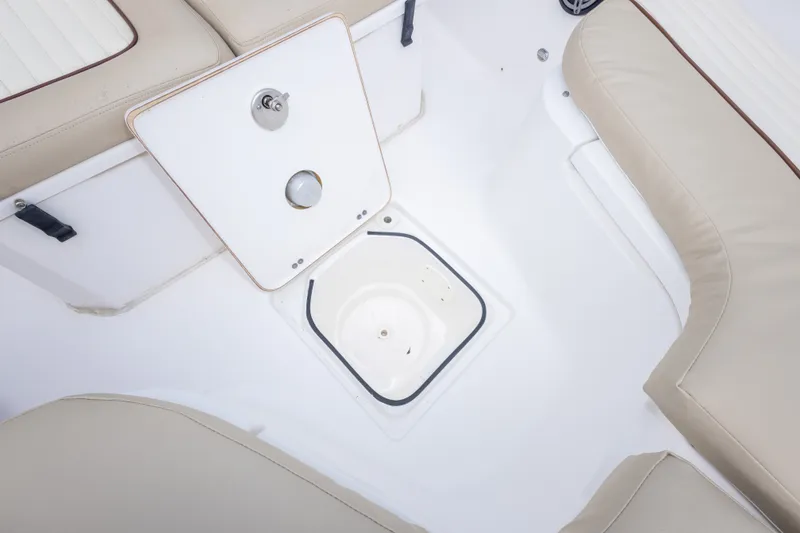 Slide: The Image of 2016 Sea Fox 288 Commander boat interior with beige seating and storage compartment. - 43