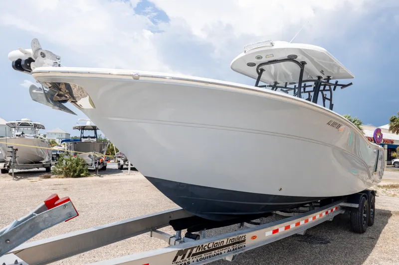 Slide: The Image of 2016 Sea Fox 288 Commander boat on trailer, parked outdoors under cloudy sky. - 17