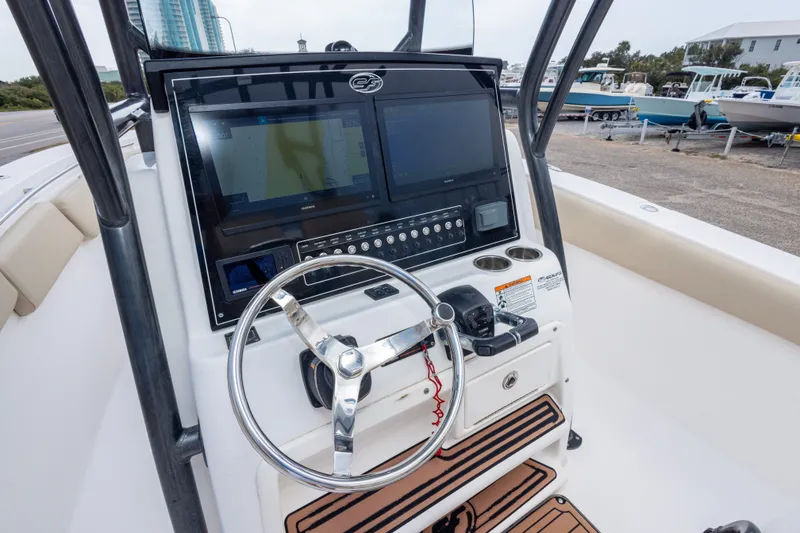 Slide: The Image of 2016 Sea Fox 288 Commander boat dashboard with steering wheel and navigation screens. - 28