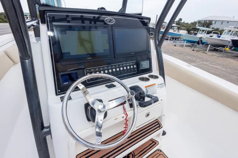 Slide: The Image of 2016 Sea Fox 288 Commander boat dashboard with steering wheel and navigation screens. - 27
