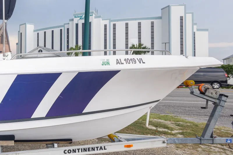 Slide: The Image of 2011 PROLINE 21 CC SE boat on trailer, hotel in background. - 14