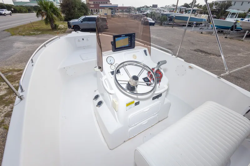 Slide: The Image of 2011 PROLINE 21 CC SE boat interior with steering console and seating. - 34