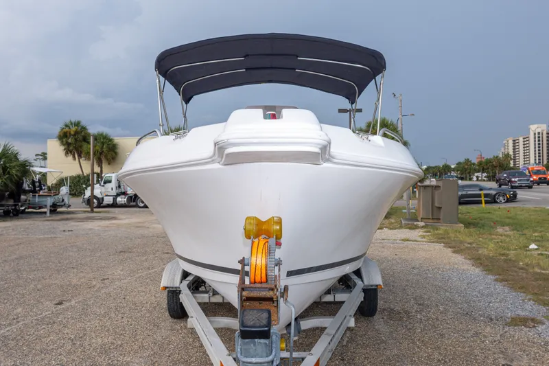 Slide: The Image of 2011 PROLINE 21 CC SE boat on trailer, parked outdoors under cloudy sky. - 39