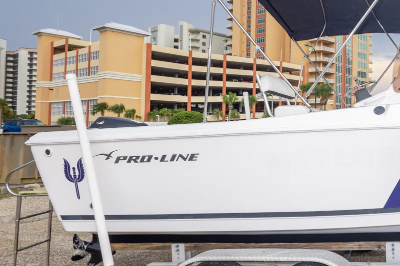 Slide: The Image of 2011 PROLINE 21 CC SE boat on trailer, urban background with buildings. - 13