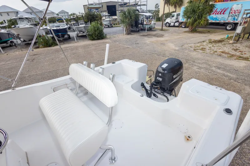 Slide: The Image of 2011 PROLINE 21 CC SE boat with Suzuki 115 outboard motor in a marina setting. - 18
