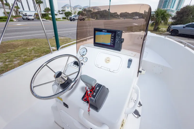Slide: The Image of 2011 PROLINE 21 CC SE boat dashboard with steering wheel and navigation system. - 32