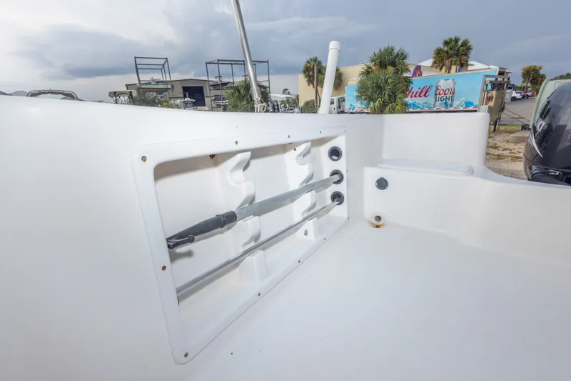 Slide: The Image of 2011 PROLINE 21 CC SE boat interior with rod holders and storage compartment. - 20