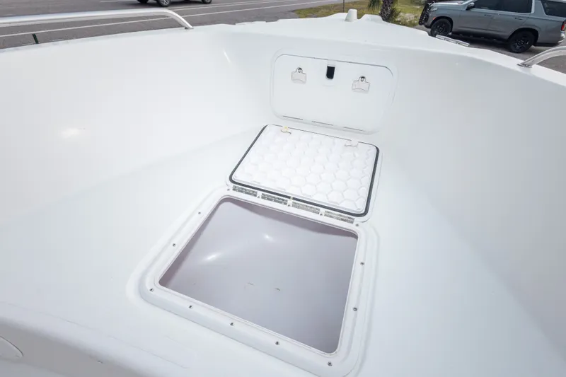 Slide: The Image of 2011 PROLINE 21 CC SE boat storage compartment with open hatch, showcasing interior space. - 25
