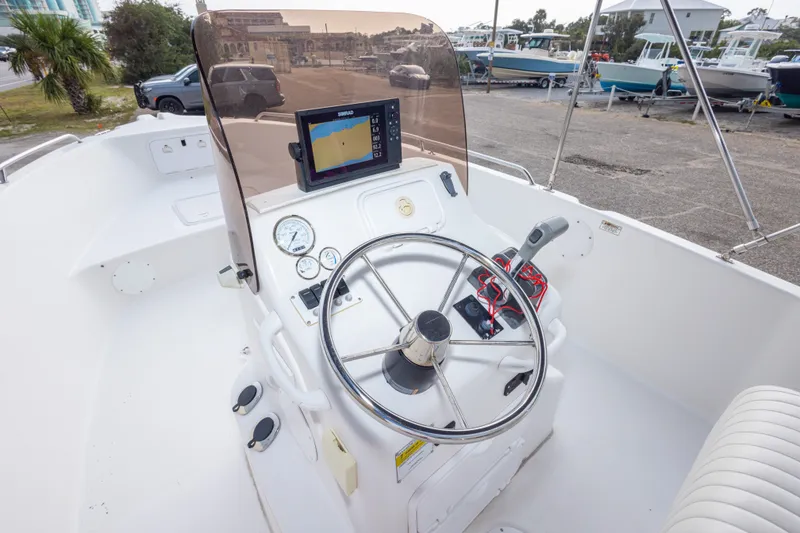 Slide: The Image of 2011 PROLINE 21 CC SE boat cockpit with steering wheel and navigation system. - 31