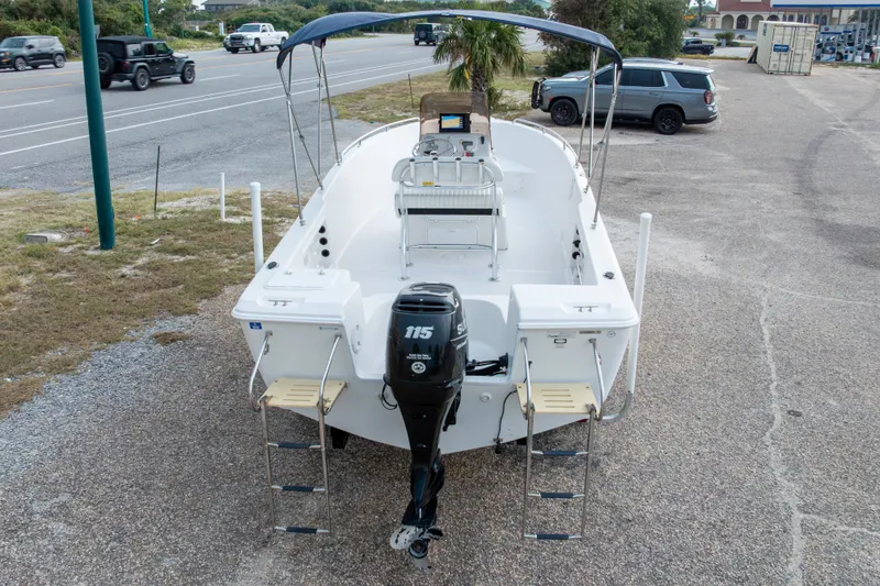 Slide: The Image of 2011 PROLINE 21 CC SE boat with Suzuki 115 engine, parked near a road. - 45