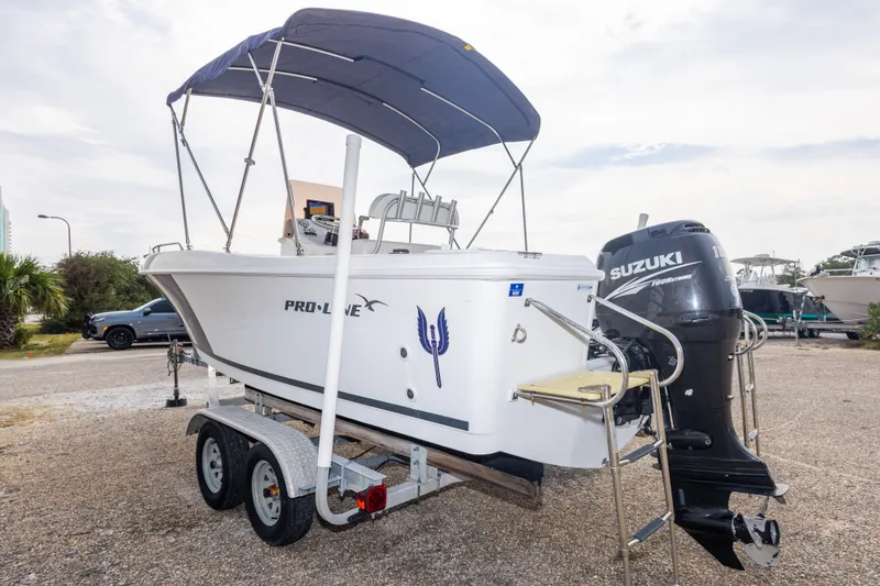Slide: The Image of 2011 PROLINE 21 CC SE boat with Suzuki outboard motor on trailer. - 40