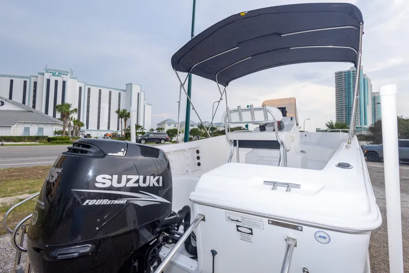 Slide: The Image of 2011 PROLINE 21 CC SE boat with Suzuki Four Stroke engine, parked near modern buildings. - 38
